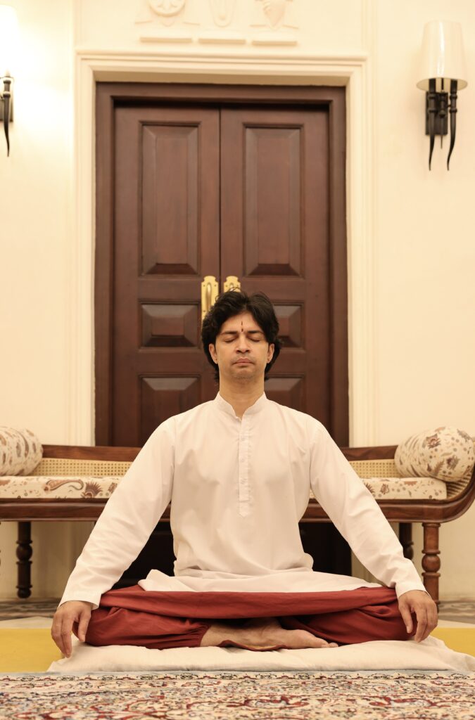 A teacher in seated meditation, Padmasana, inside the ashram at Rishikesh