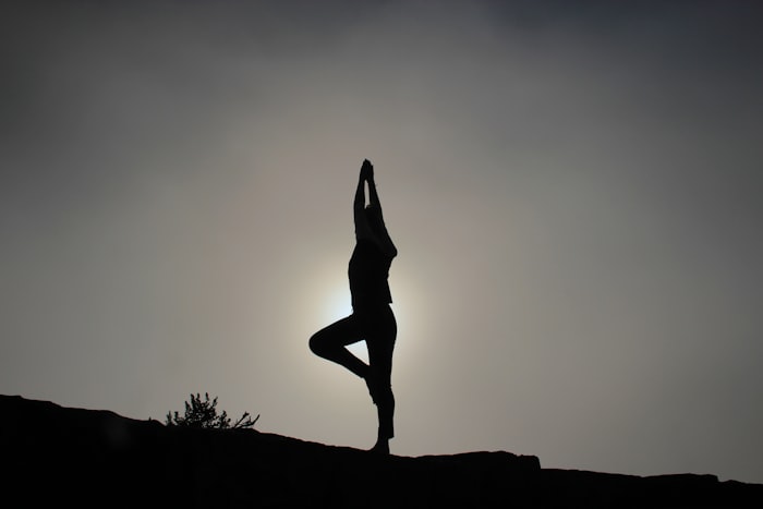 A yoga silhouette at sunrise, symbolic of energy and inner healing at Parasha Foundation