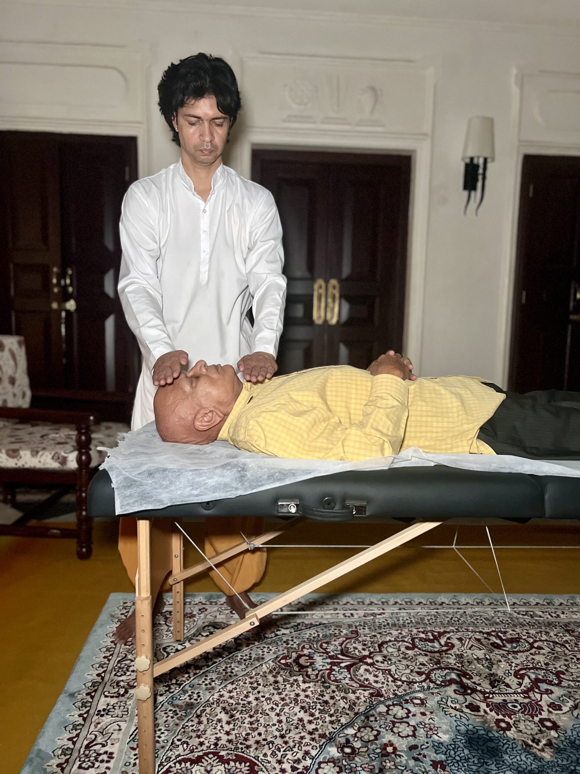 A Reiki practitioner giving a hands-on healing session at the Parasha ashram in Rishikesh
