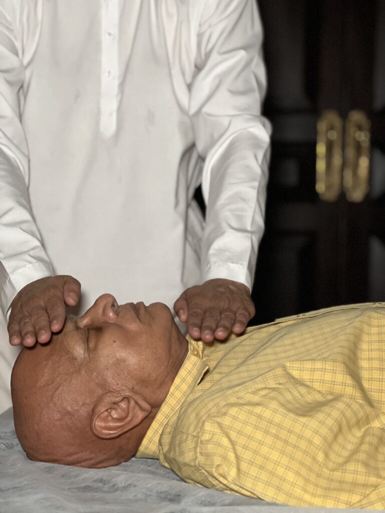A student in seated meditation beside the Ganga